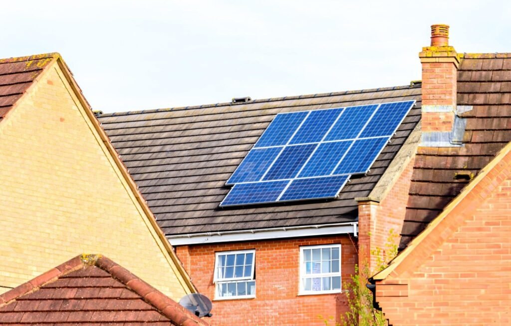 A traditional red-brick UK home featuring a roof-mounted solar panel array, representing a typical domestic 10-panel installation to safeguard against utility price spikes.