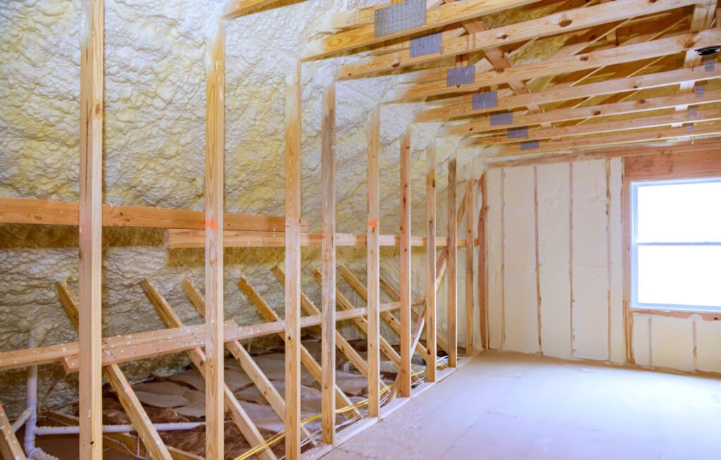 Loft room insulated with spray foam insulation between timber beams