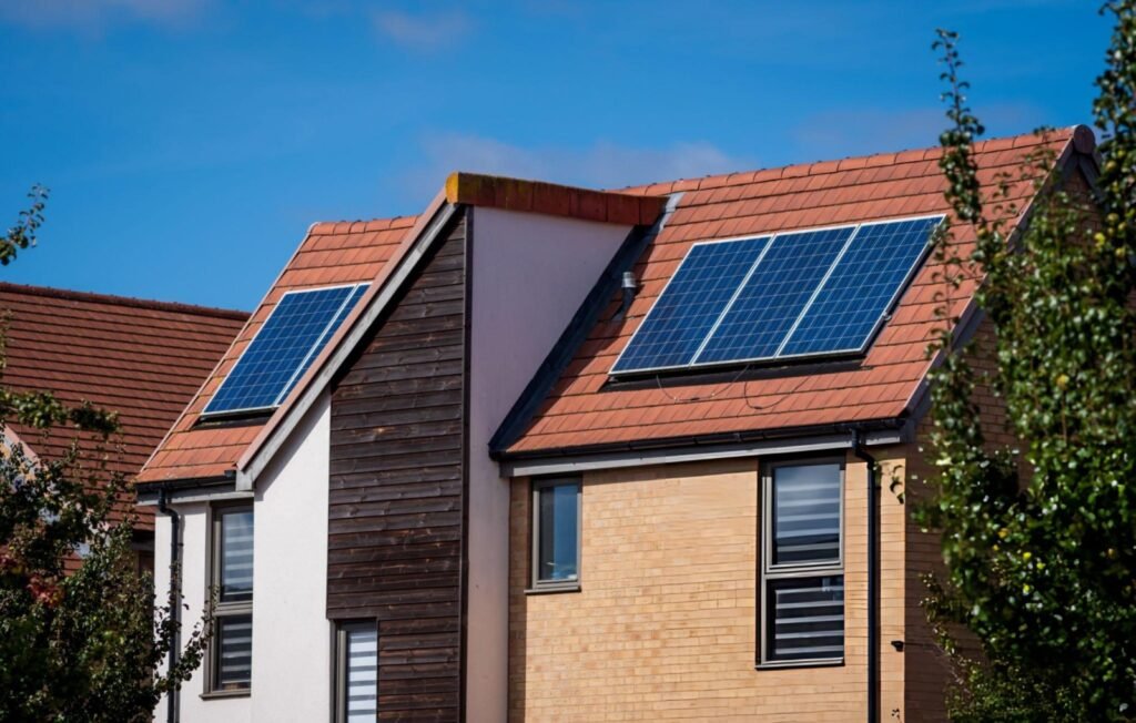 Modern, energy-efficient UK houses with integrated rooftop solar panels, illustrating high-efficiency retrofits that improve long-term property value.